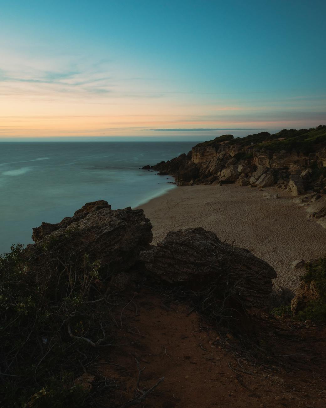view of a rocky shore at sunset