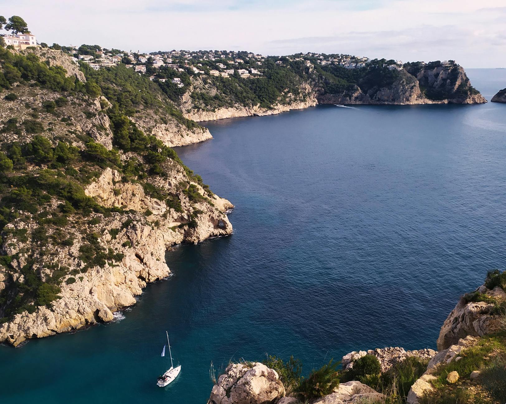aerial view of a sailboat near the shore in granadella spain
