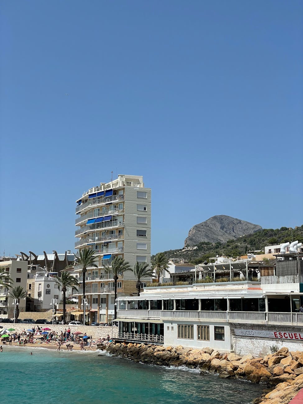 coastal view of beachfront buildings and mountain
